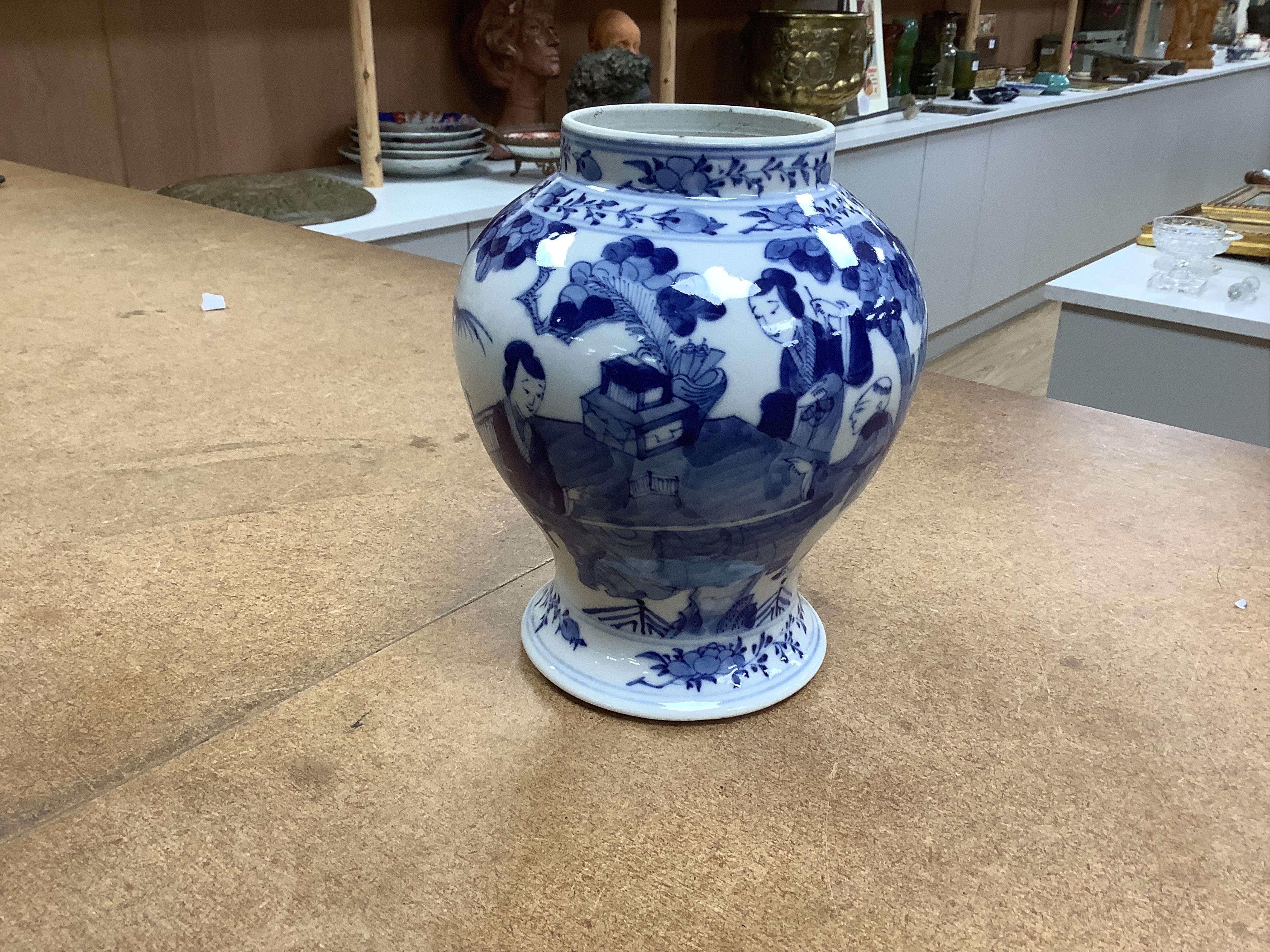 An early 20th century Chinese blue and white porcelain vase and cover decorated with figures in a landscape and a Japanese circular bowl, tallest 23cm. Condition - good